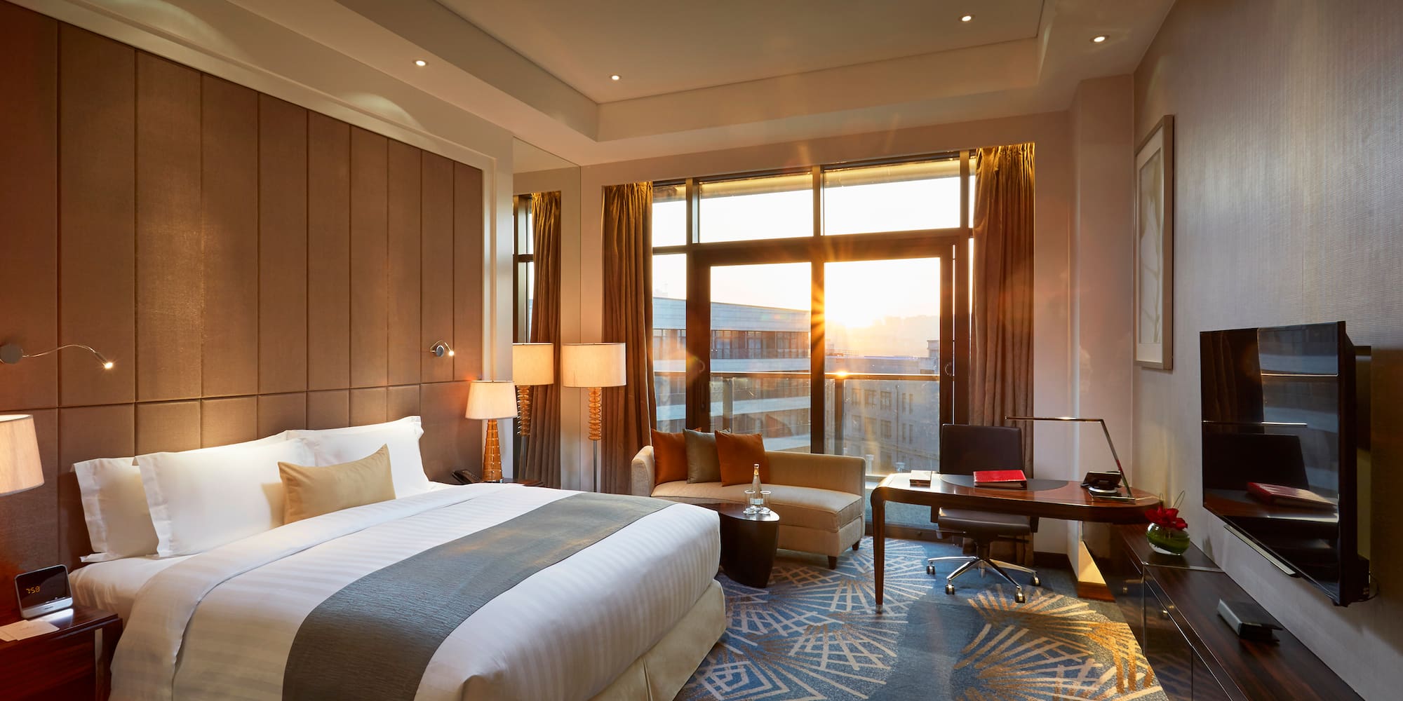 a room with a bed and a desk and a chair