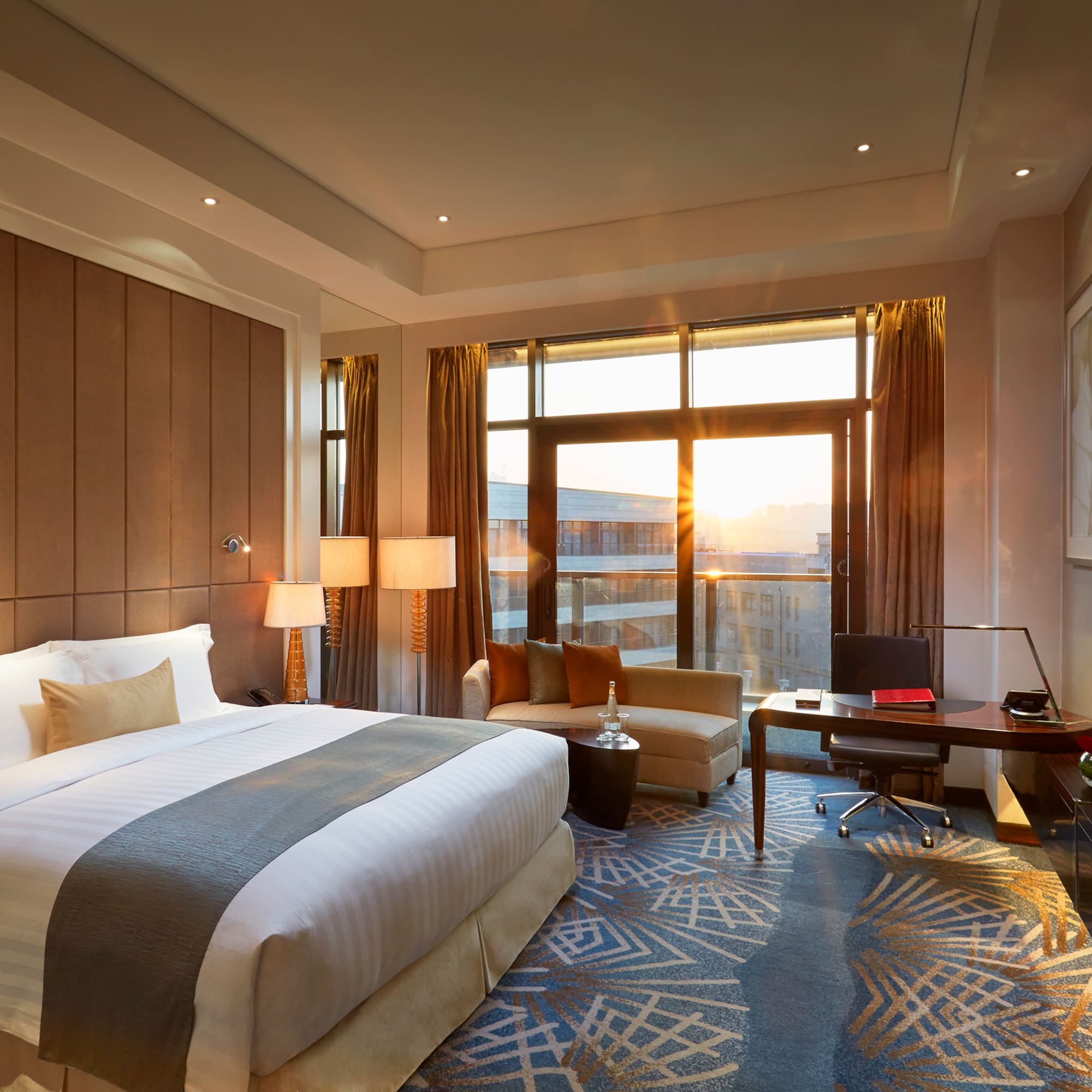 a room with a bed and a desk and a chair