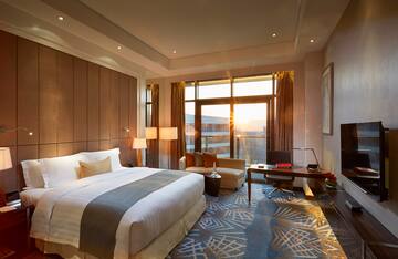 a room with a bed and a desk and a chair