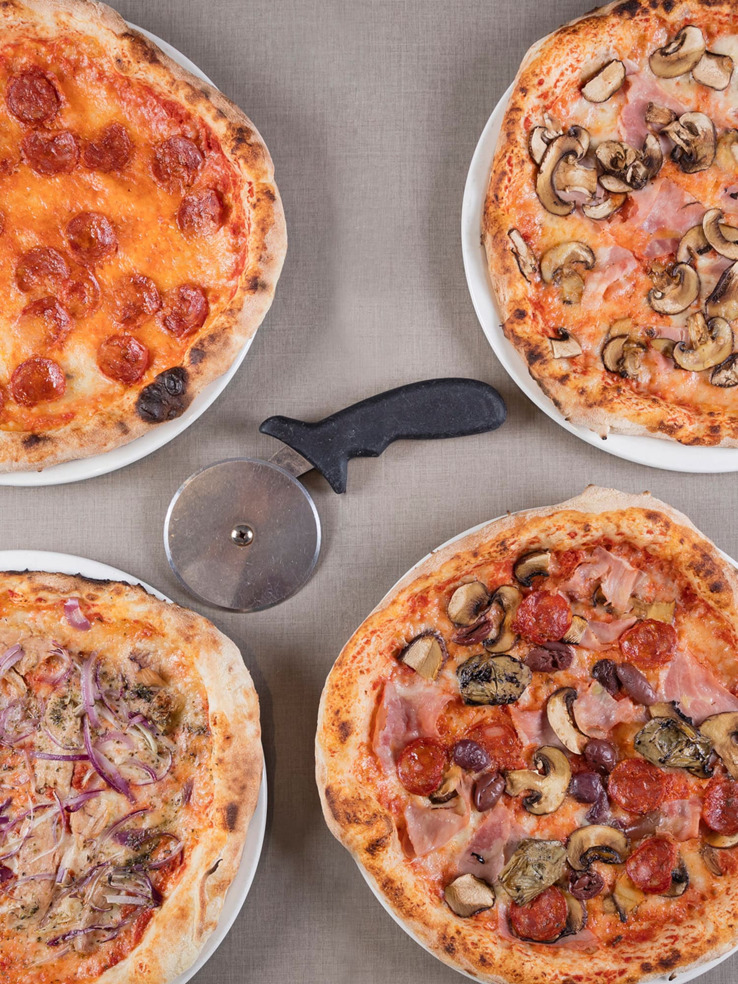 a group of pizzas on a table