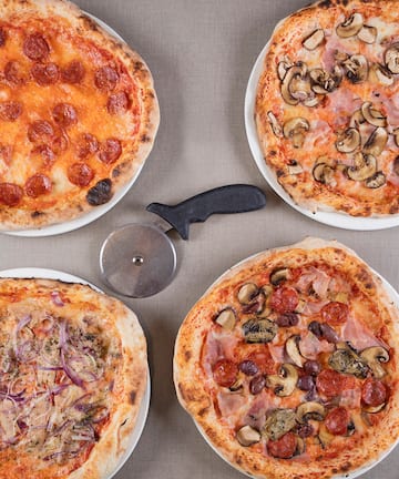 a group of pizzas on a table