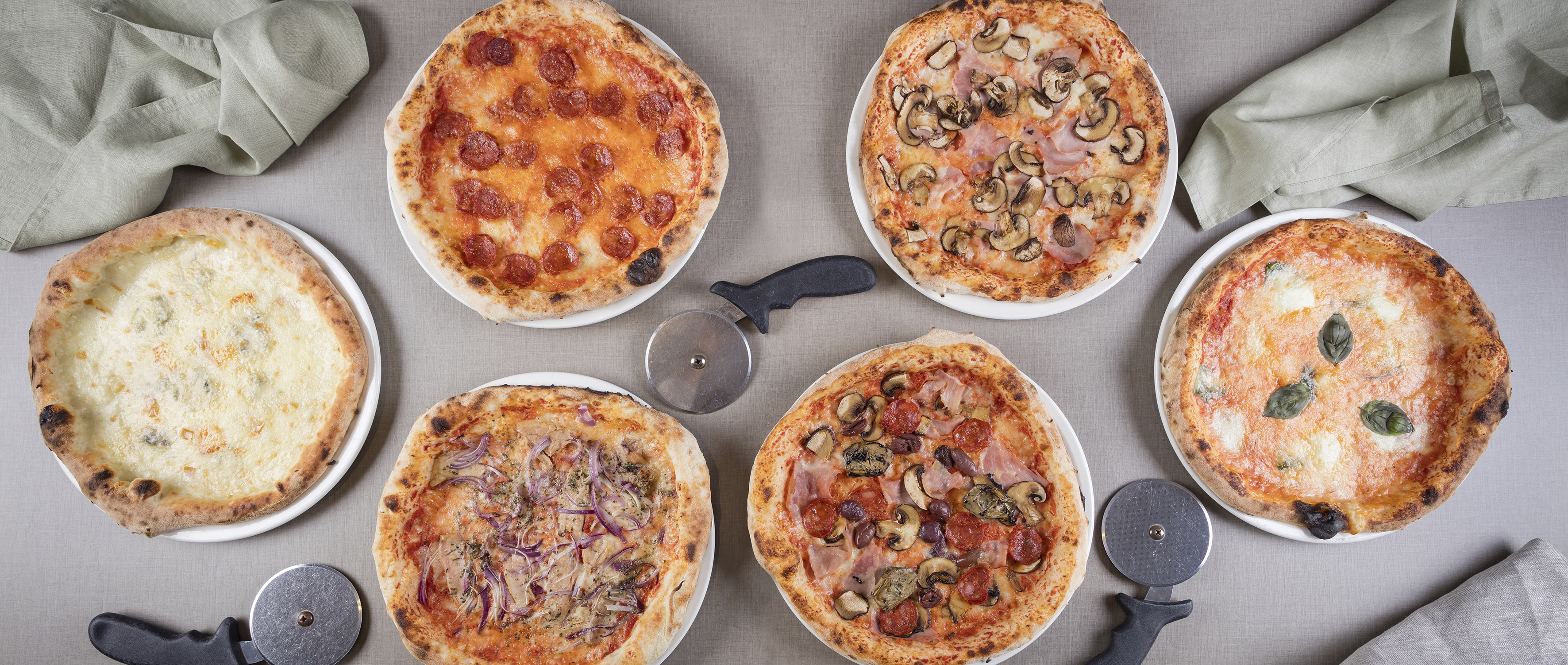 a group of pizzas on a table