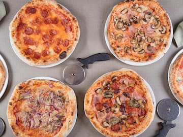 a group of pizzas on a table
