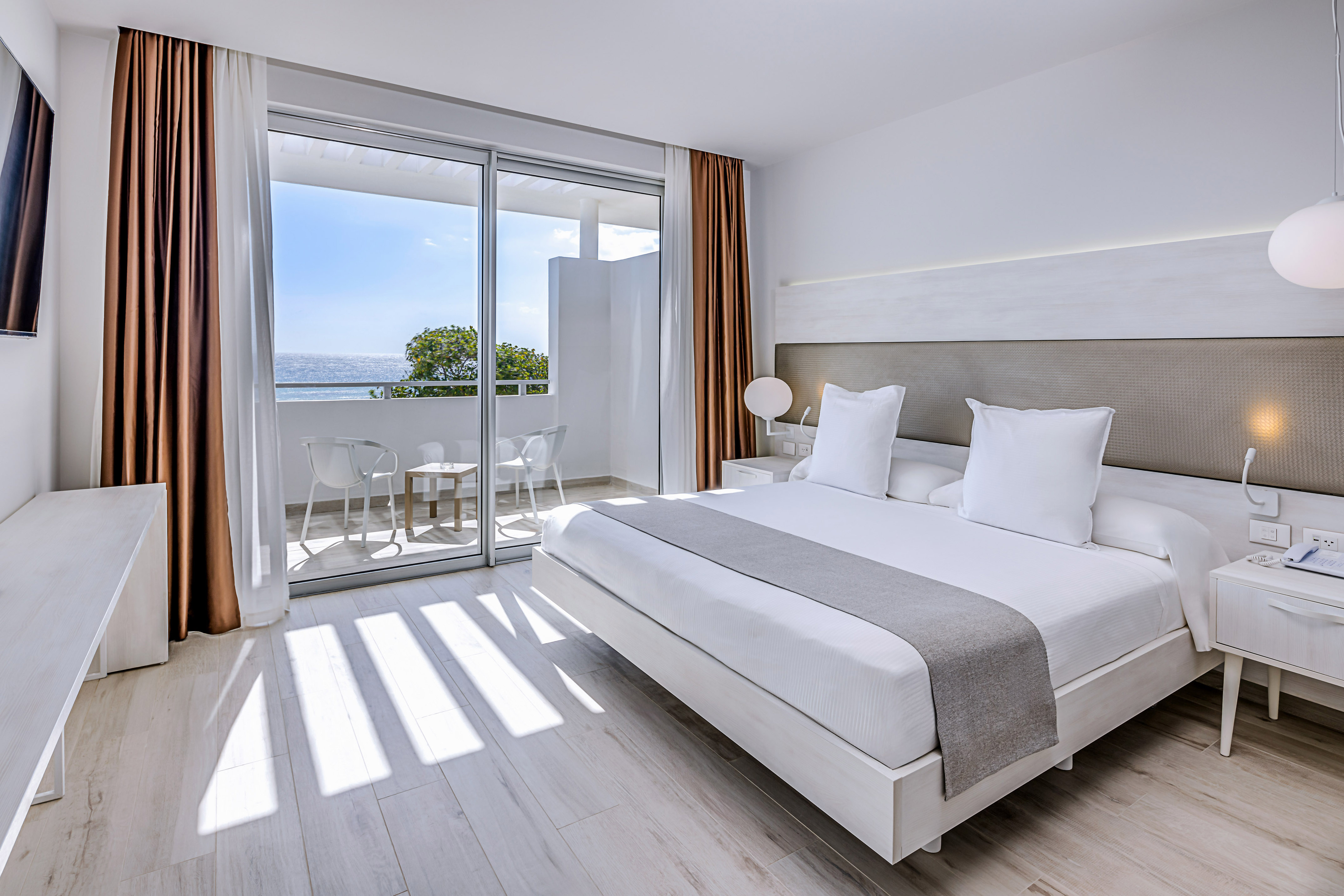 a bedroom with a large glass door