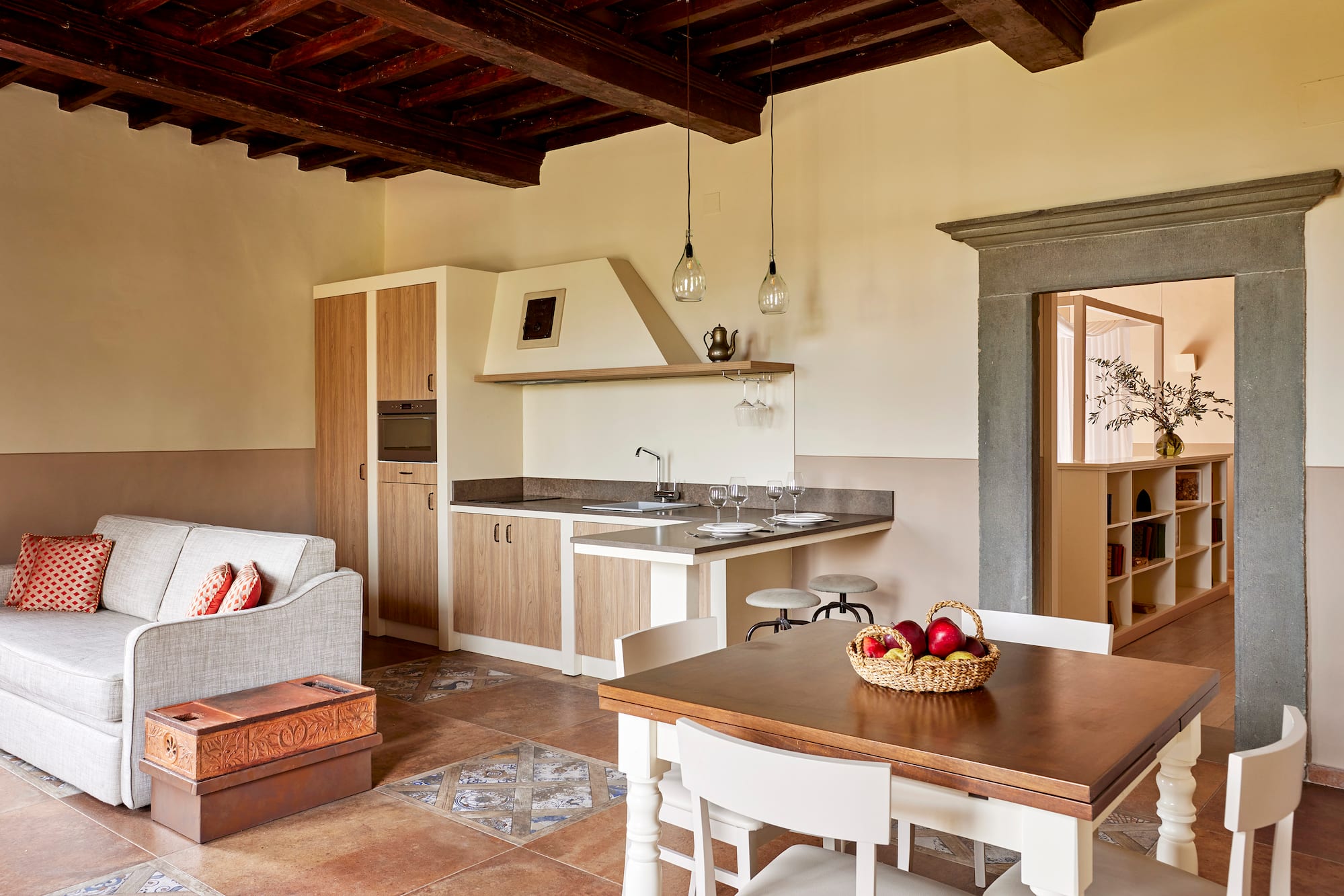 a kitchen and living room with a table and chairs