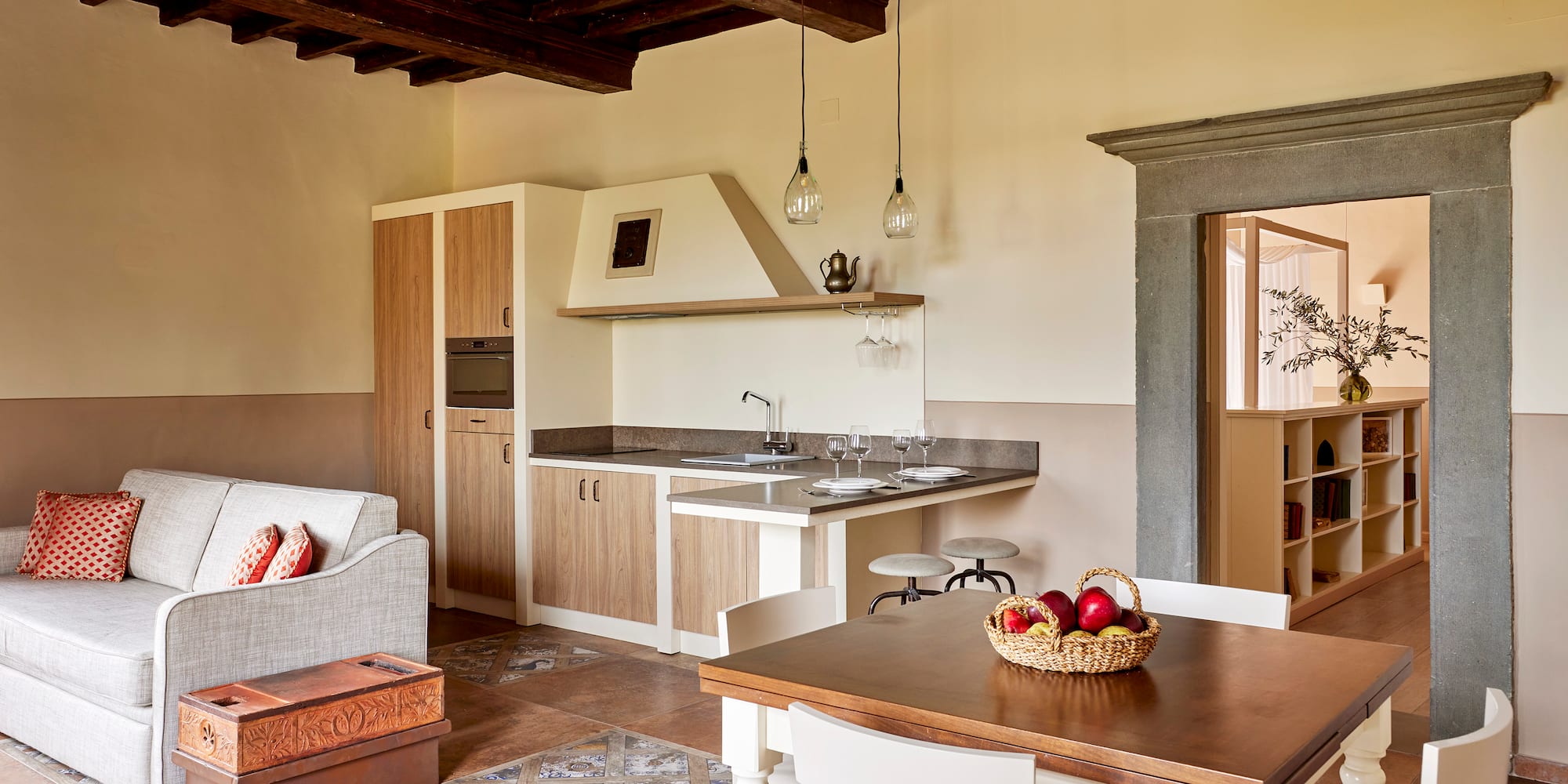 a kitchen and living room with a table and chairs