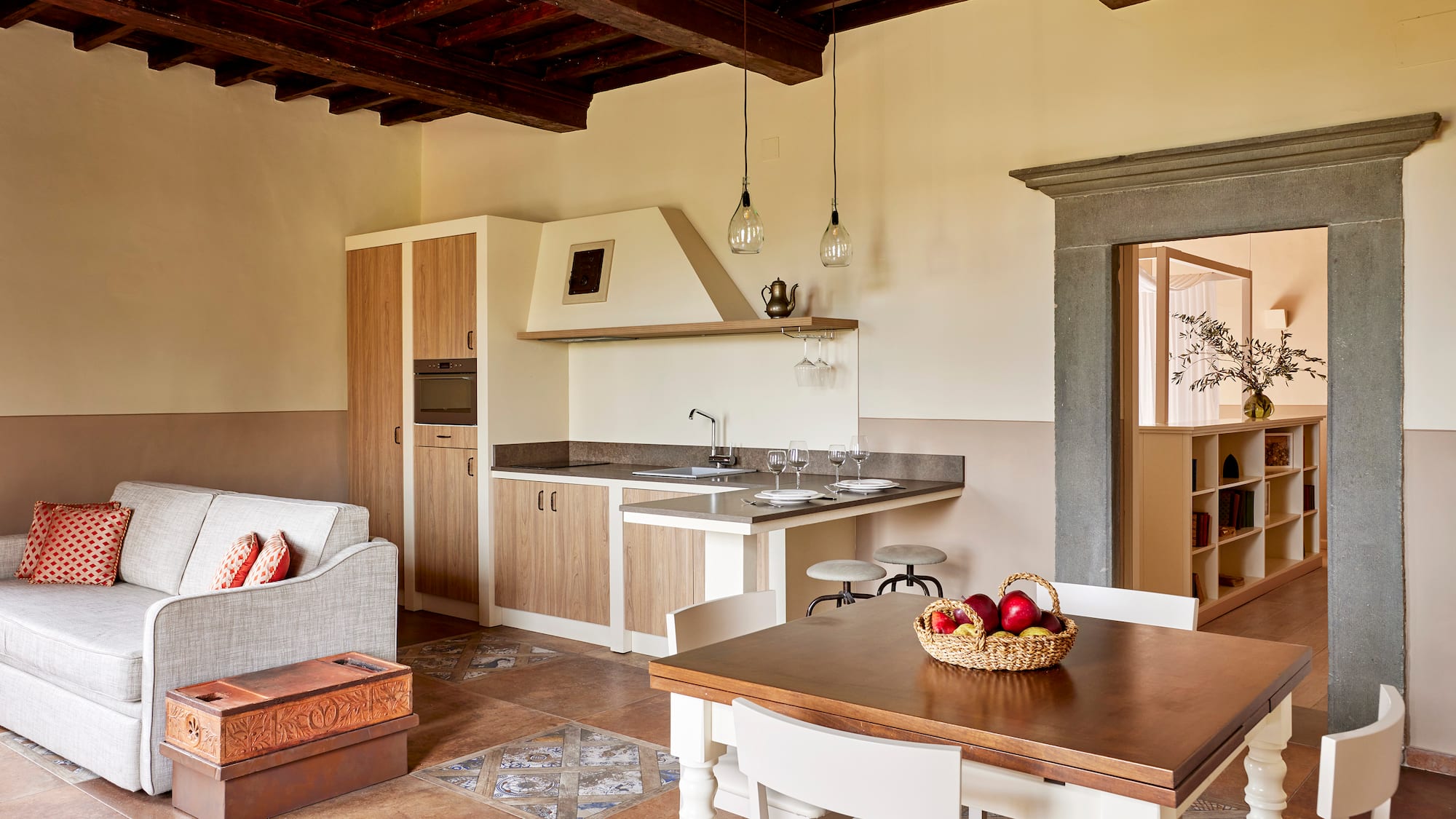a kitchen and living room with a table and chairs
