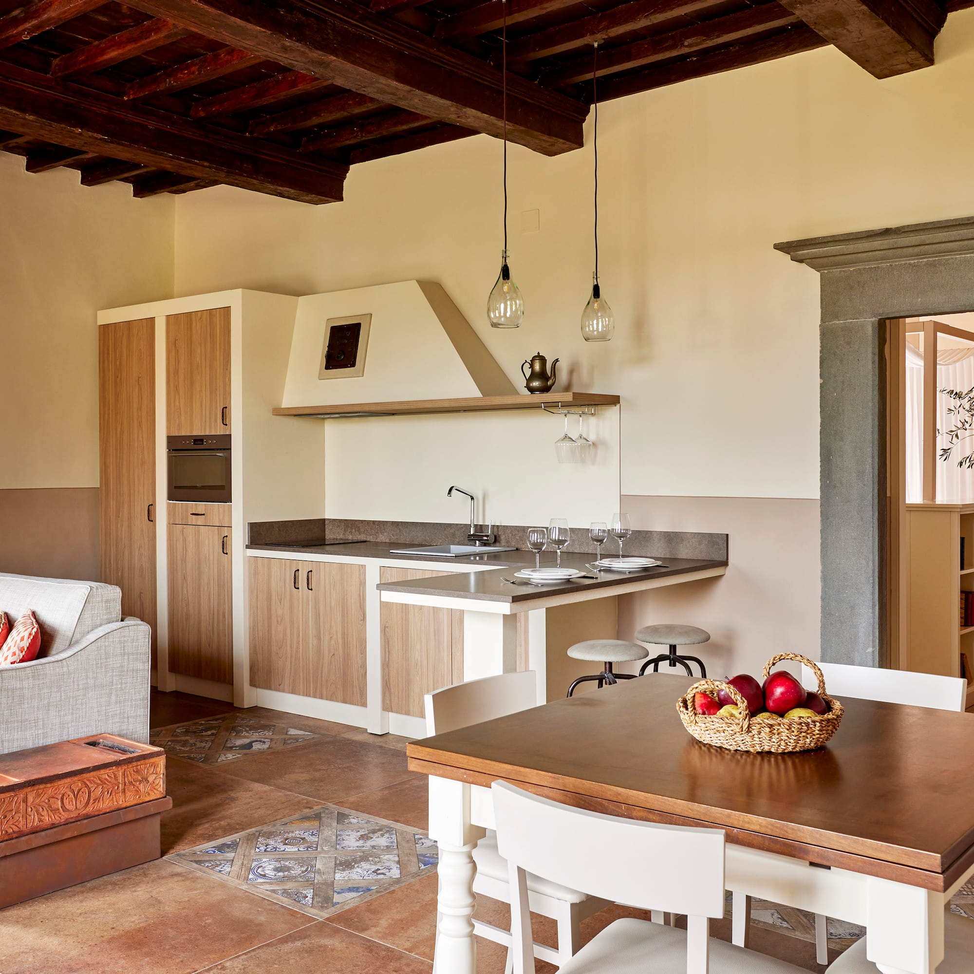 a kitchen and living room with a table and chairs