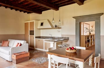 a kitchen and living room with a table and chairs
