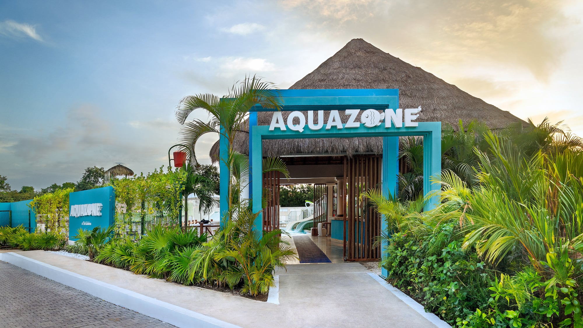 a blue sign with white letters and plants