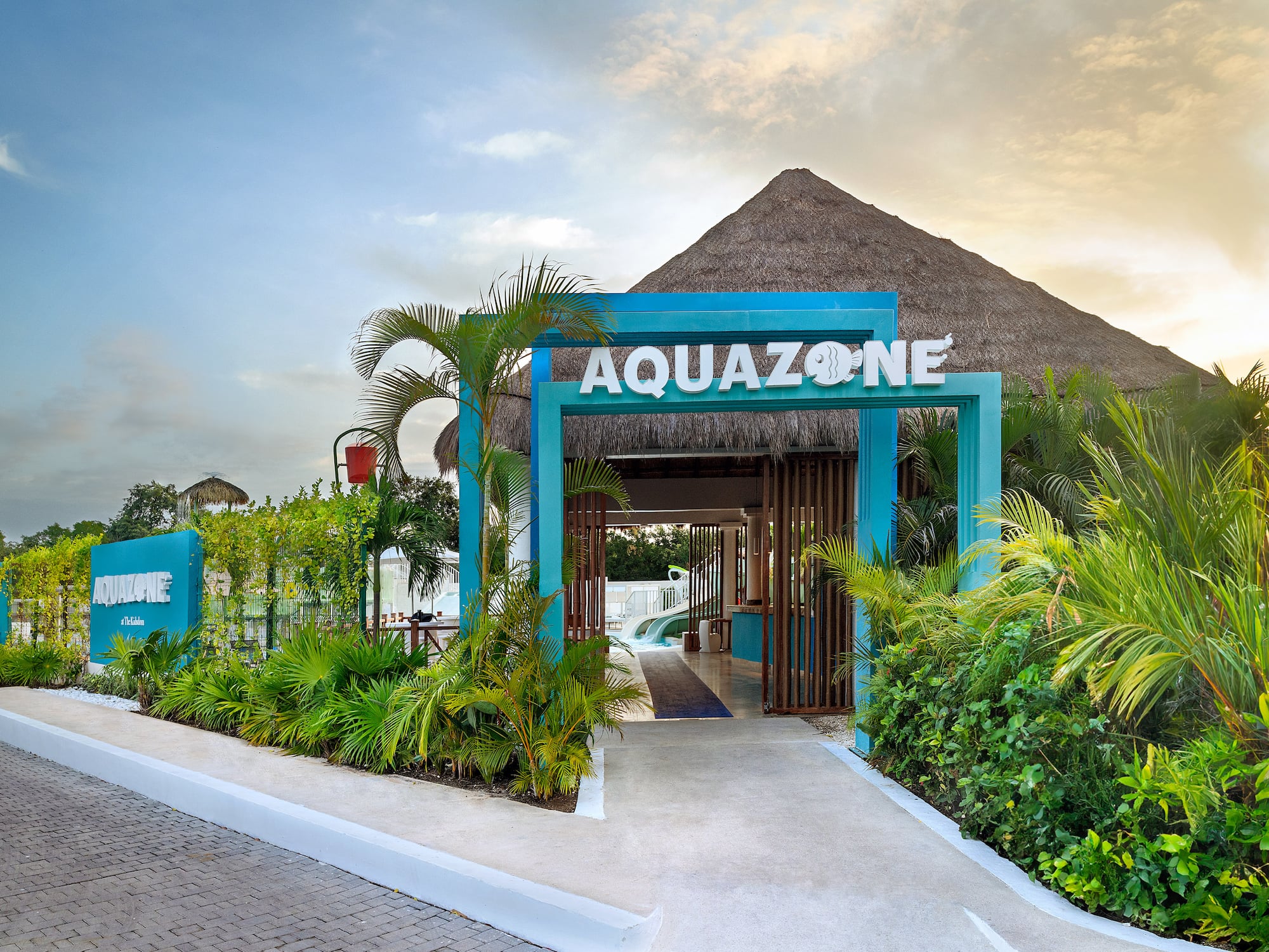 a blue sign with white letters and plants