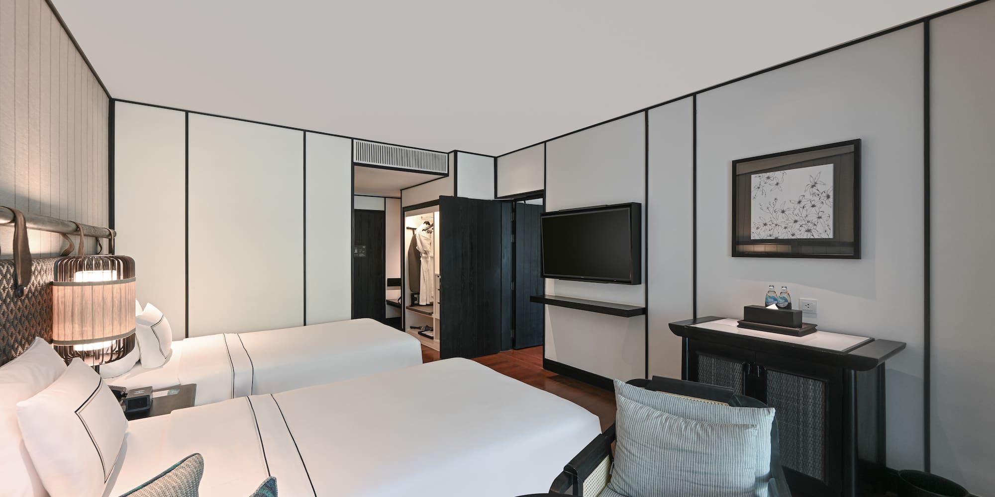 a room with two beds and a television