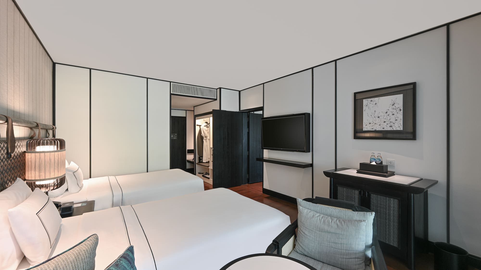 a room with two beds and a television