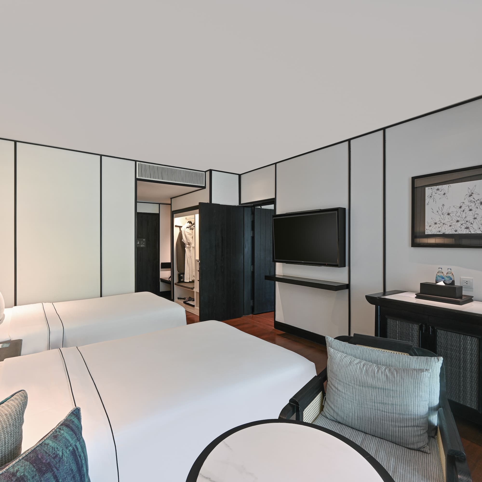 a room with two beds and a television