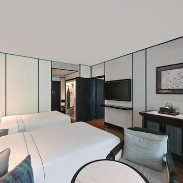 a room with two beds and a television