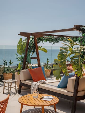 a patio with a view of the ocean