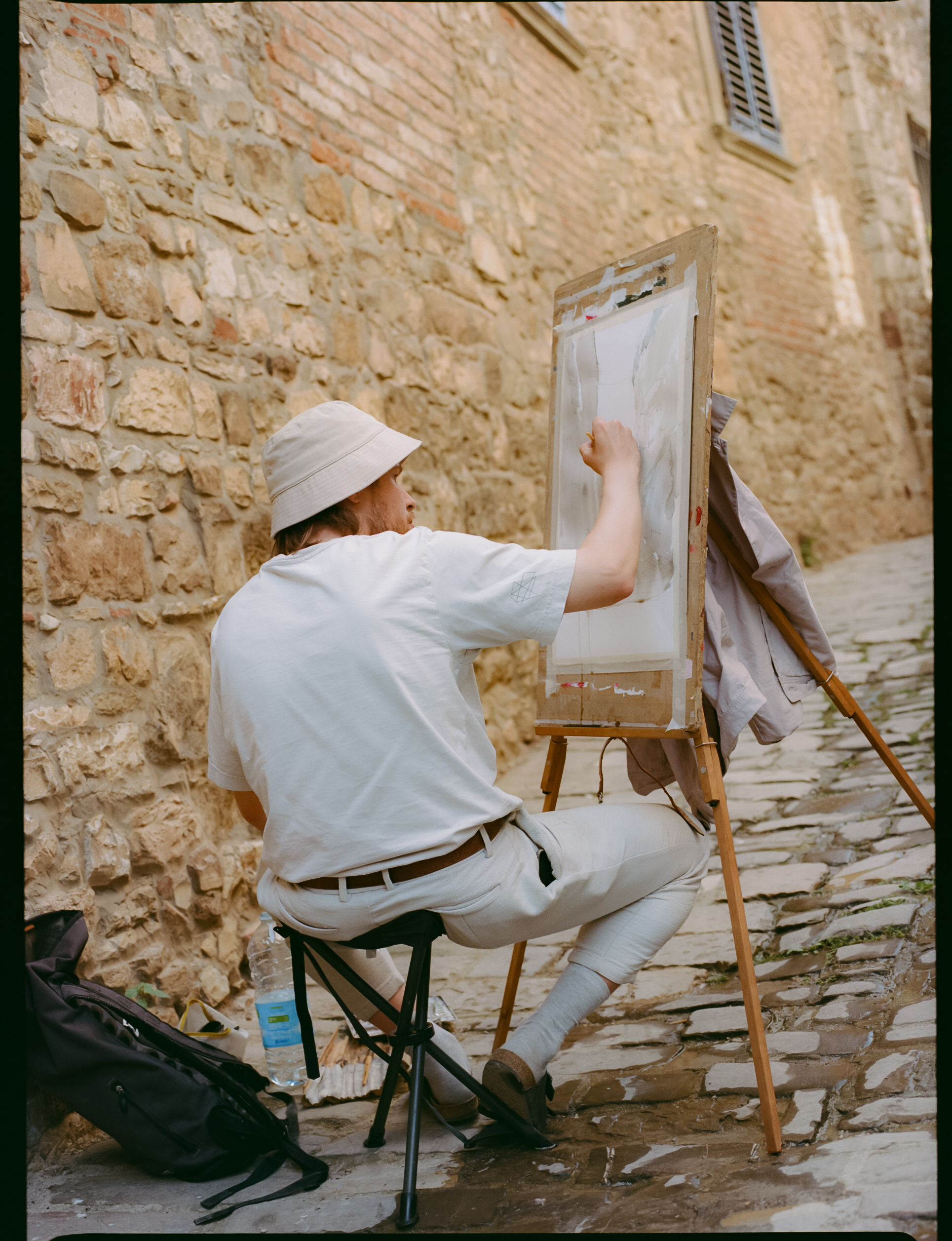 a man painting on a canvas