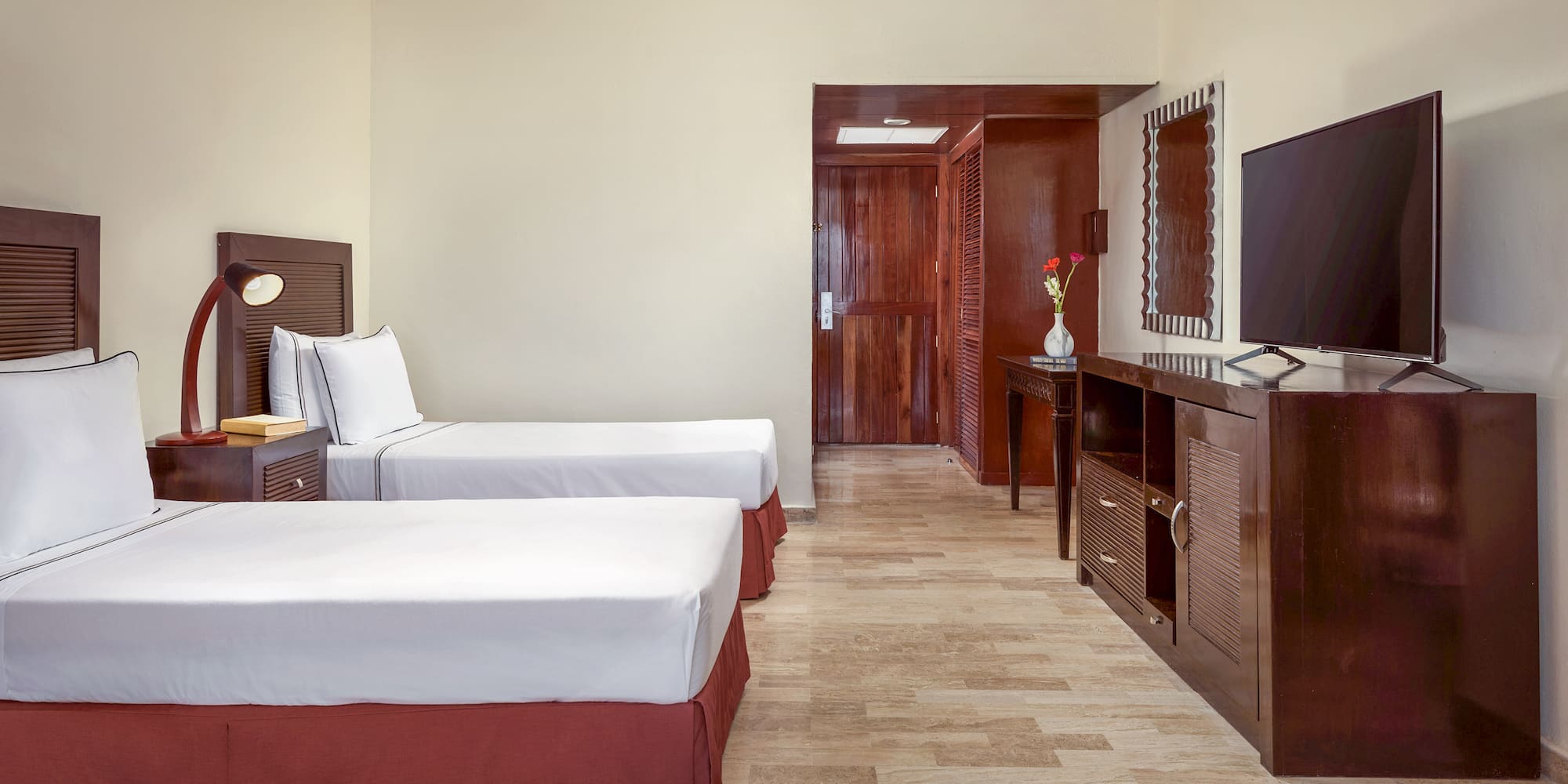 a room with two beds and a mirror