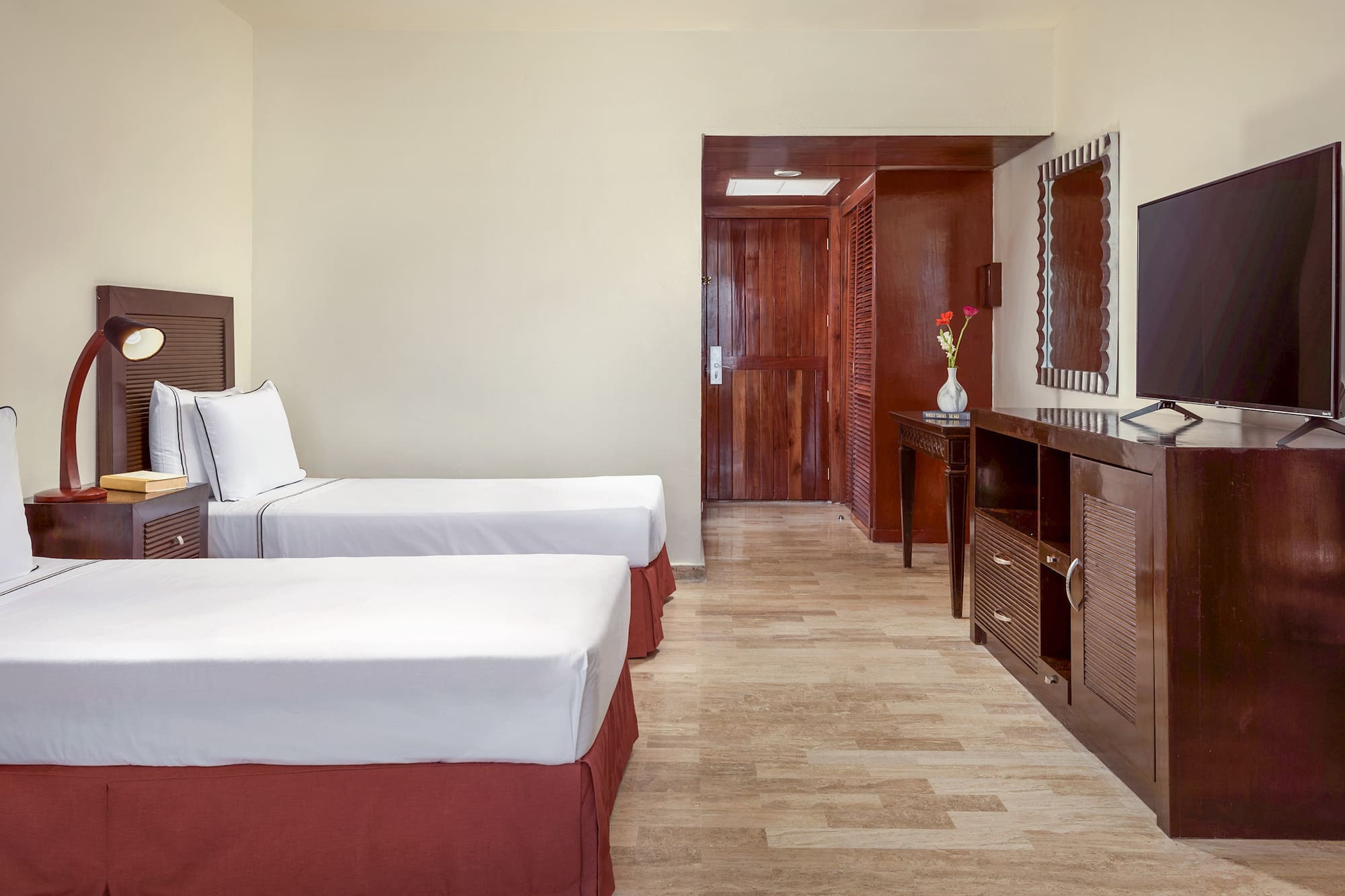 a room with two beds and a mirror