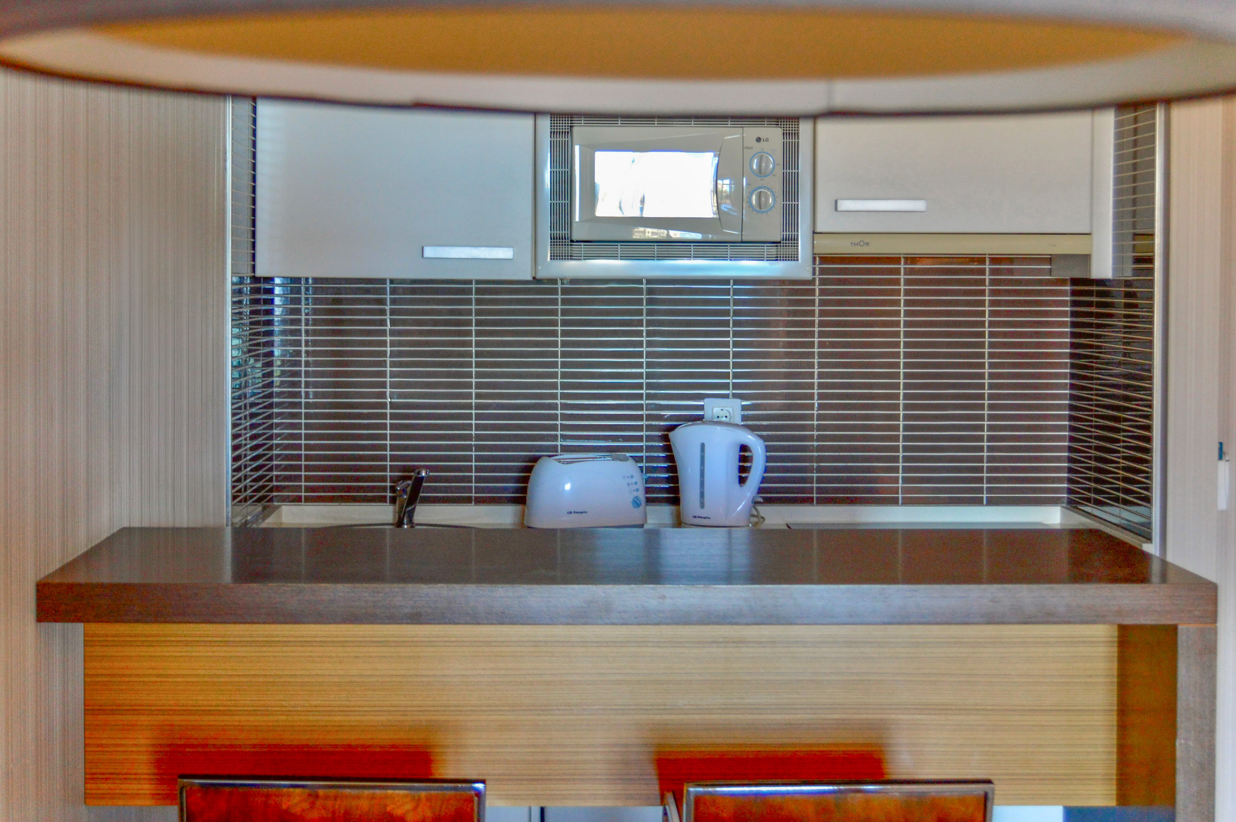 a kitchen with a microwave and a kettle