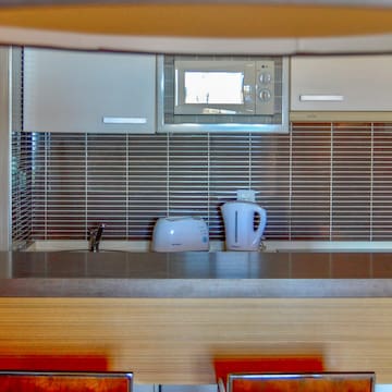a kitchen with a microwave and a kettle