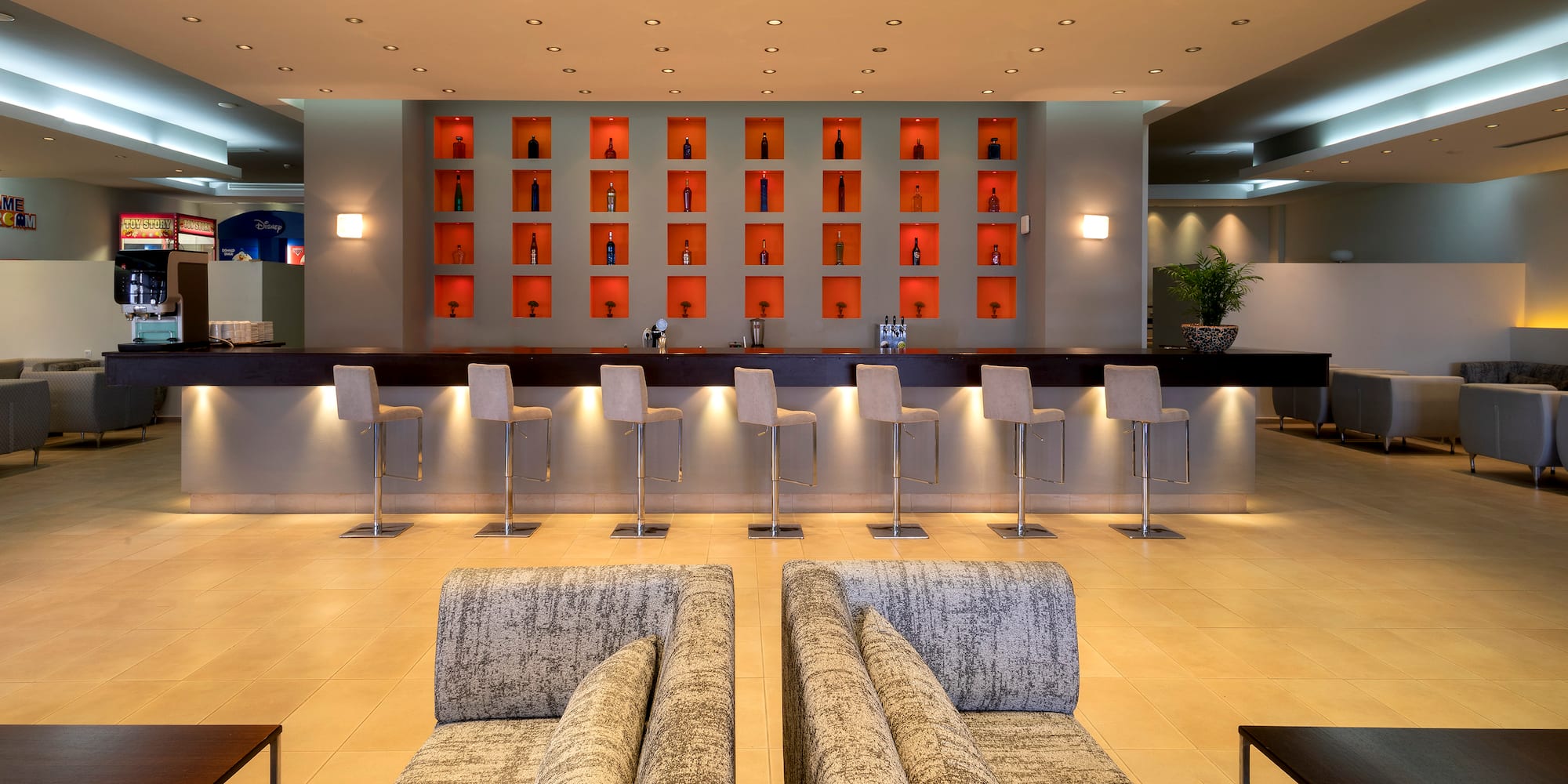 a room with a bar and chairs