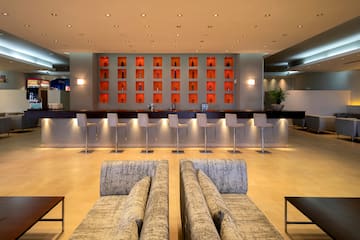 a room with a bar and chairs