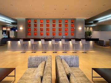 a room with a bar and chairs