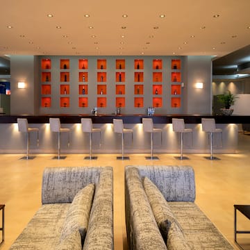 a room with a bar and chairs