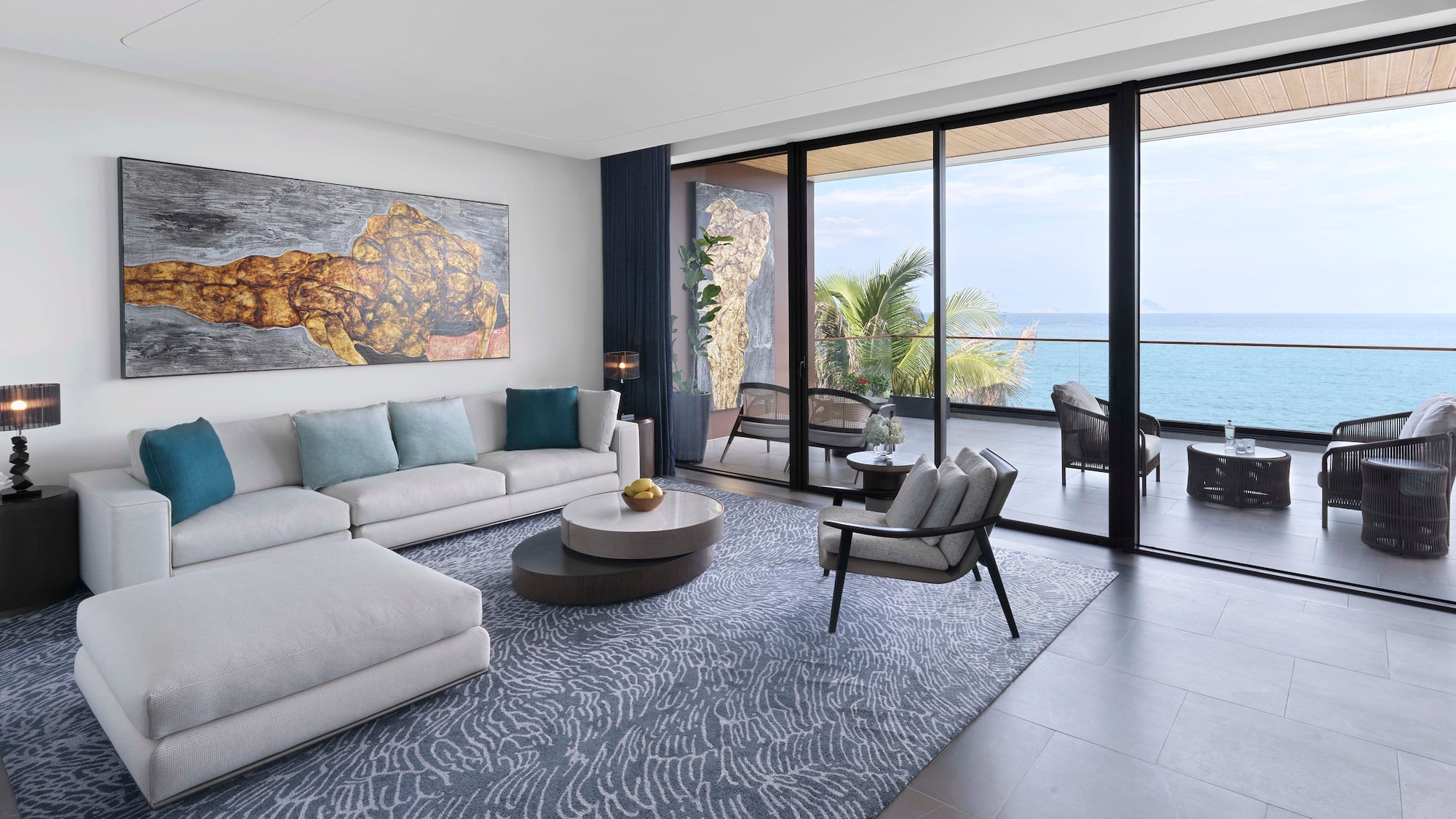 a living room with a large glass door and a large couch