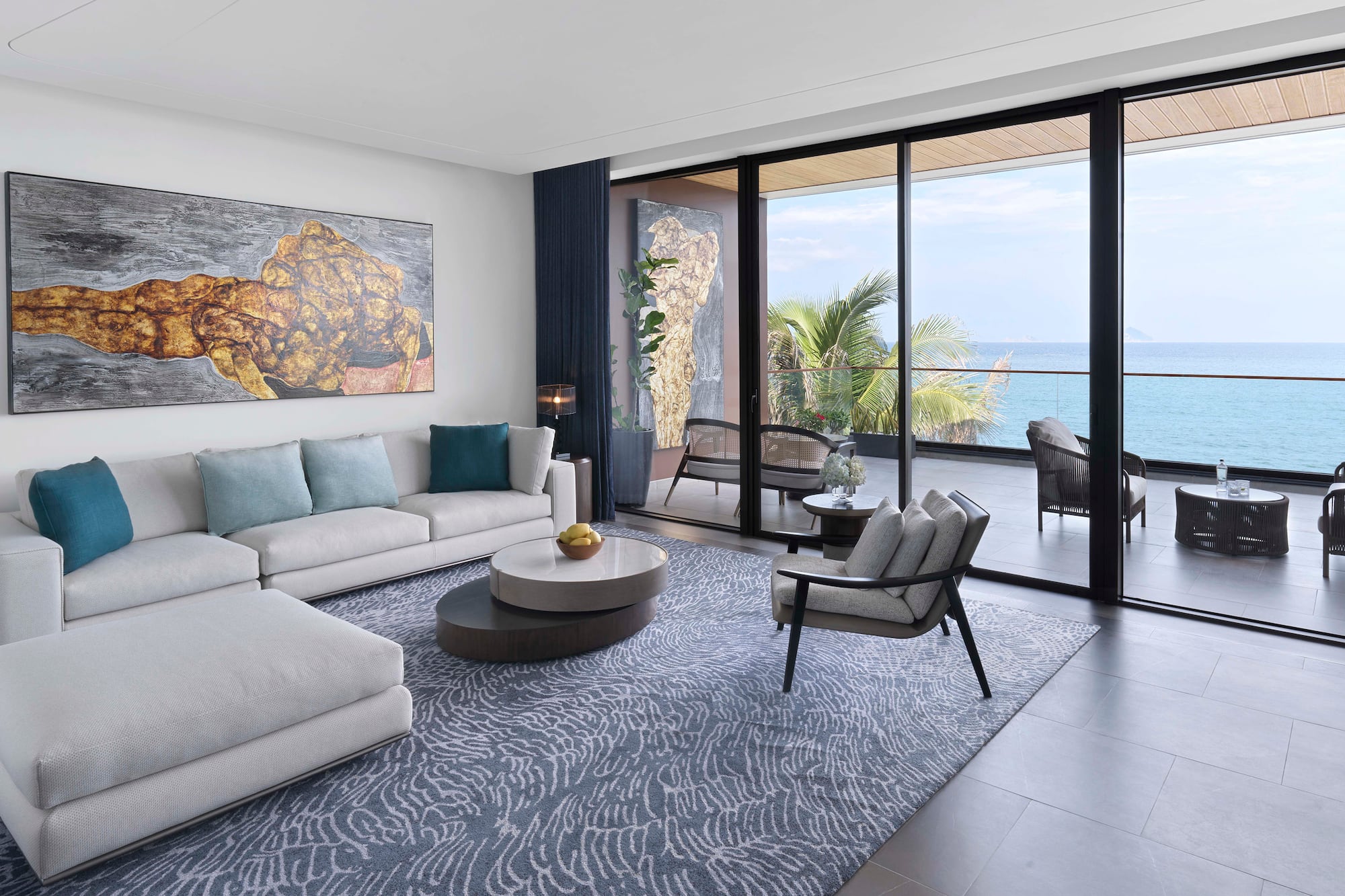 a living room with a large glass door and a large couch