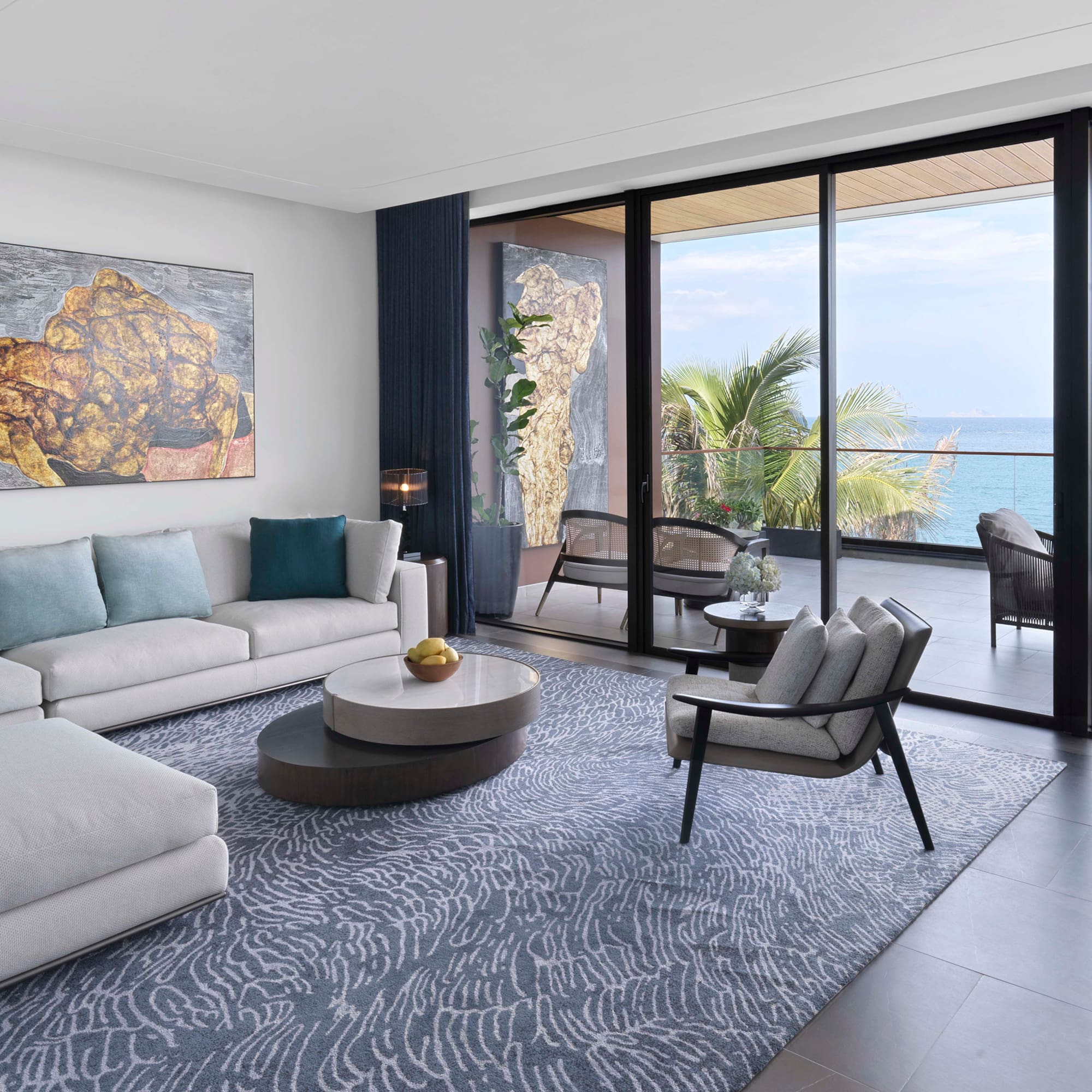 a living room with a large glass door and a large couch