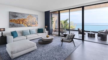 a living room with a large glass door and a large couch