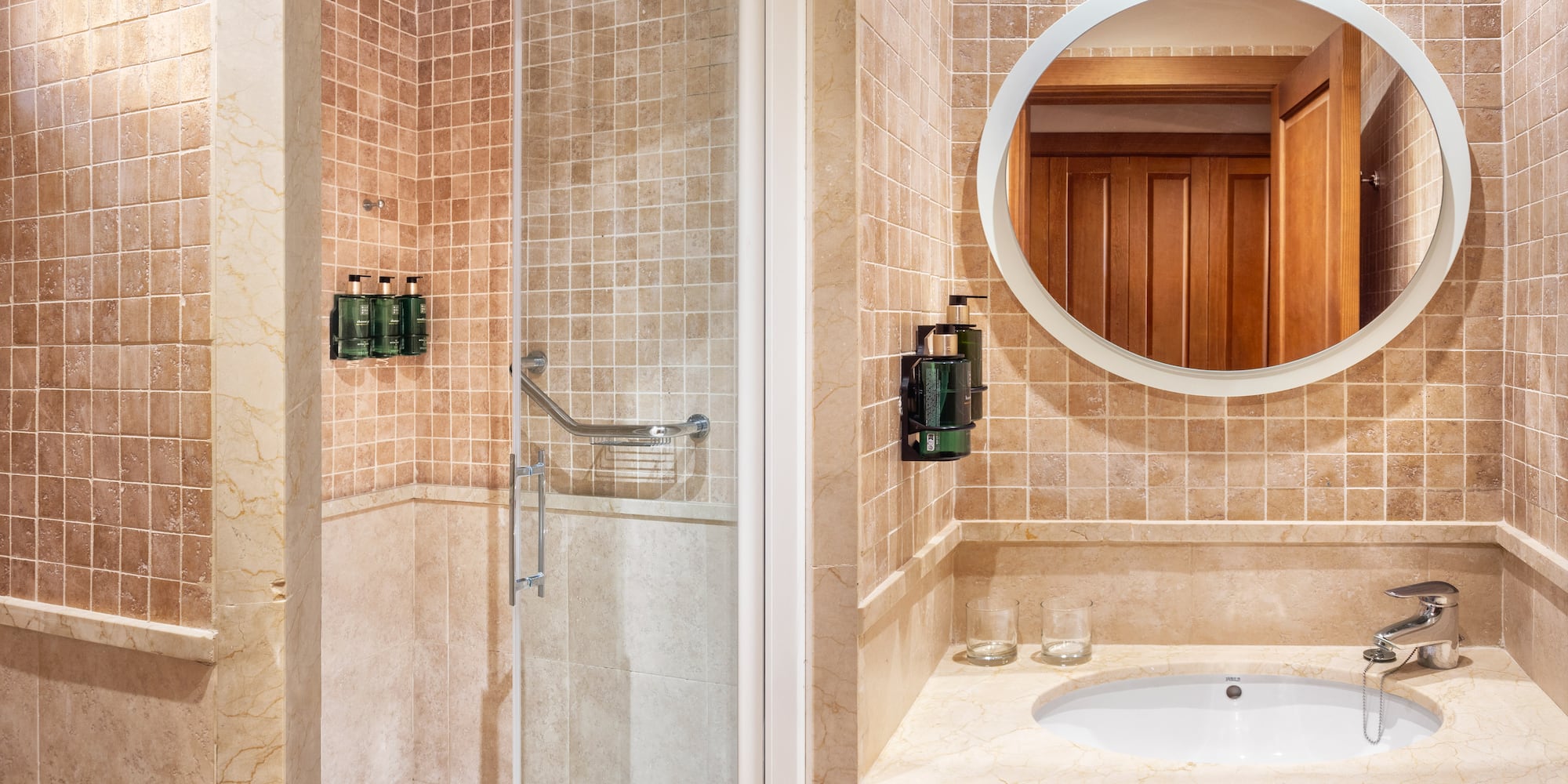 a bathroom with a mirror and shower