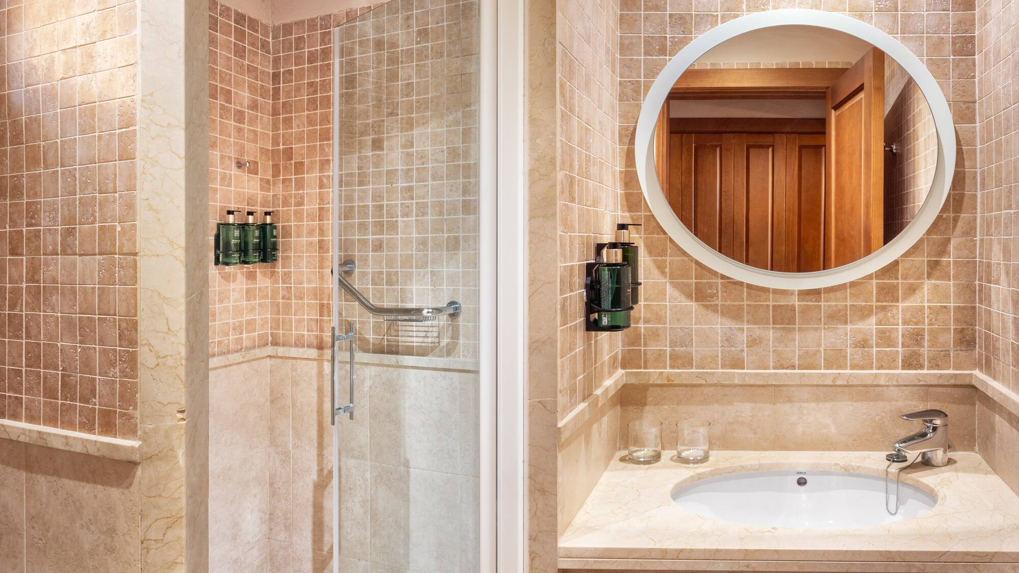 a bathroom with a mirror and shower