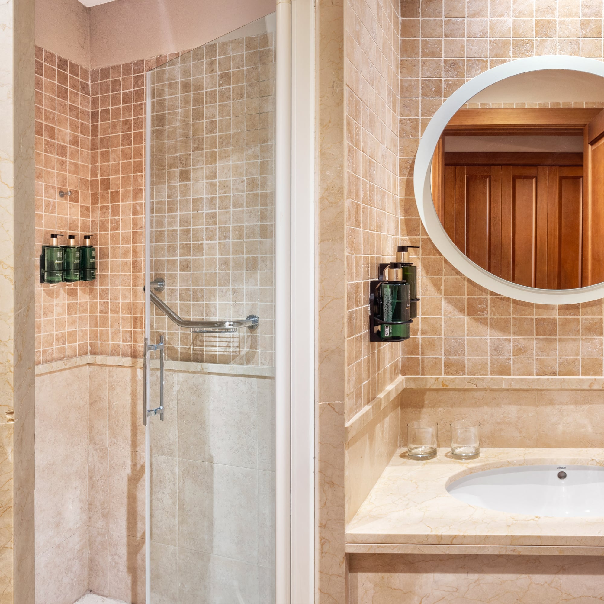 a bathroom with a mirror and shower