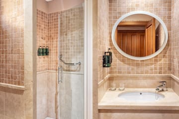 a bathroom with a mirror and shower