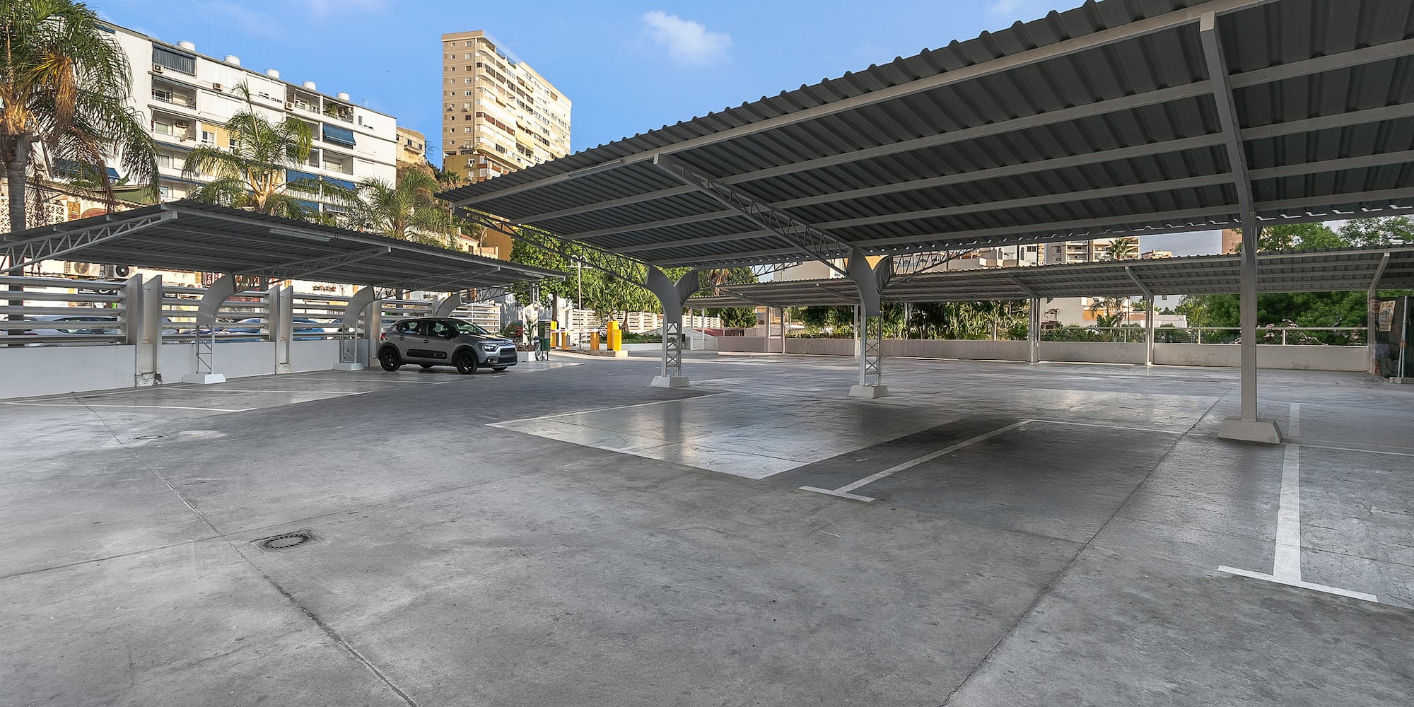 a parking lot with a car parked in the middle