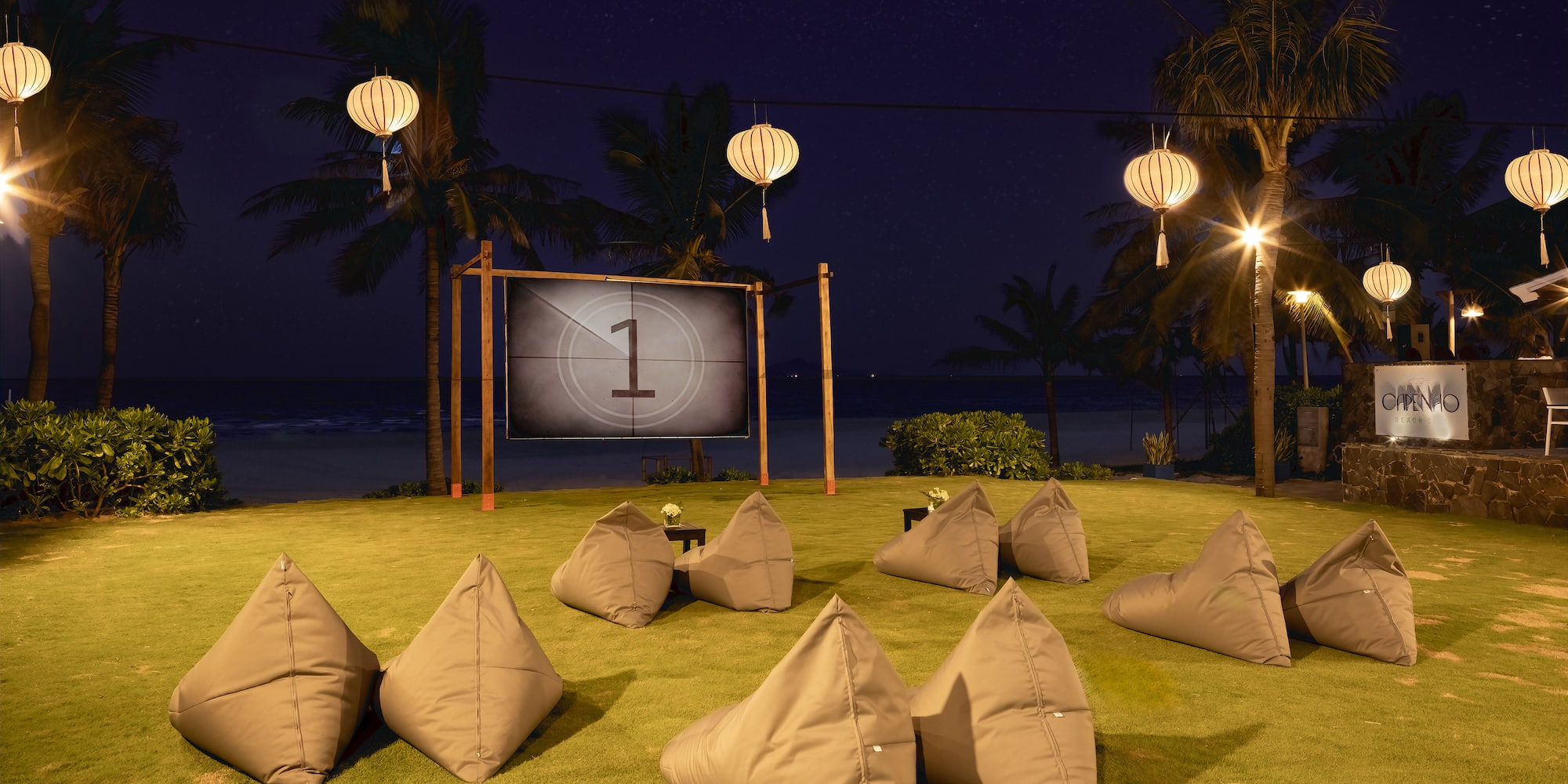 a group of pillows on grass with a screen in the background