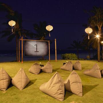 a group of pillows on grass with a screen in the background