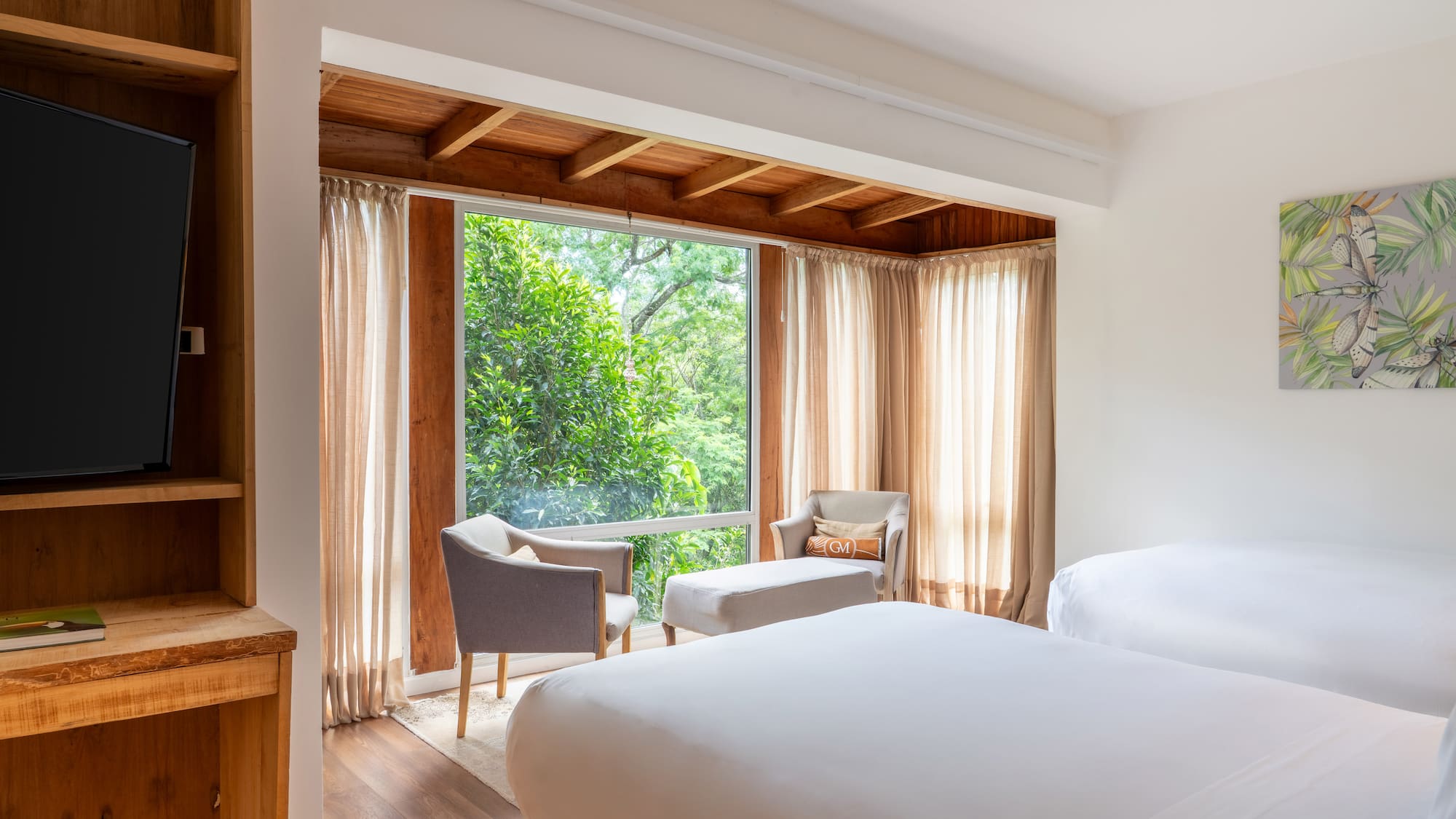 a room with a bed and chairs