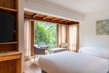 a room with a bed and chairs