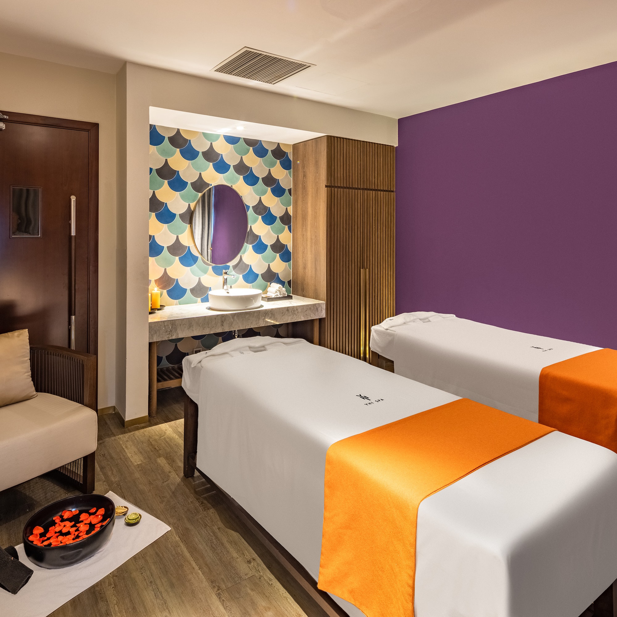 a room with two beds and a mirror