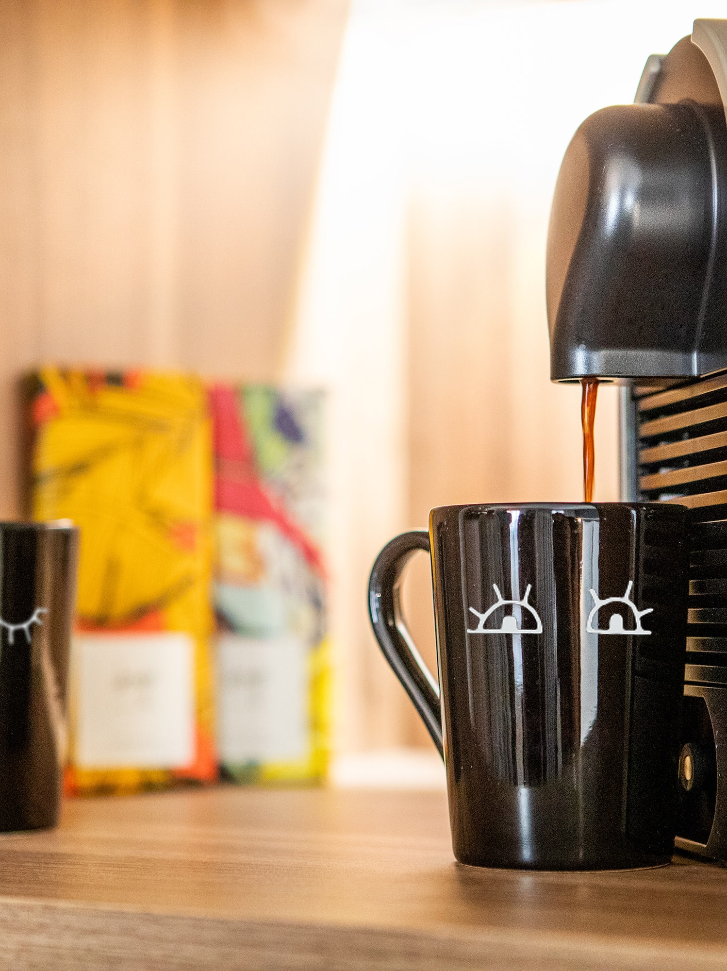 a coffee machine pouring coffee into two cups