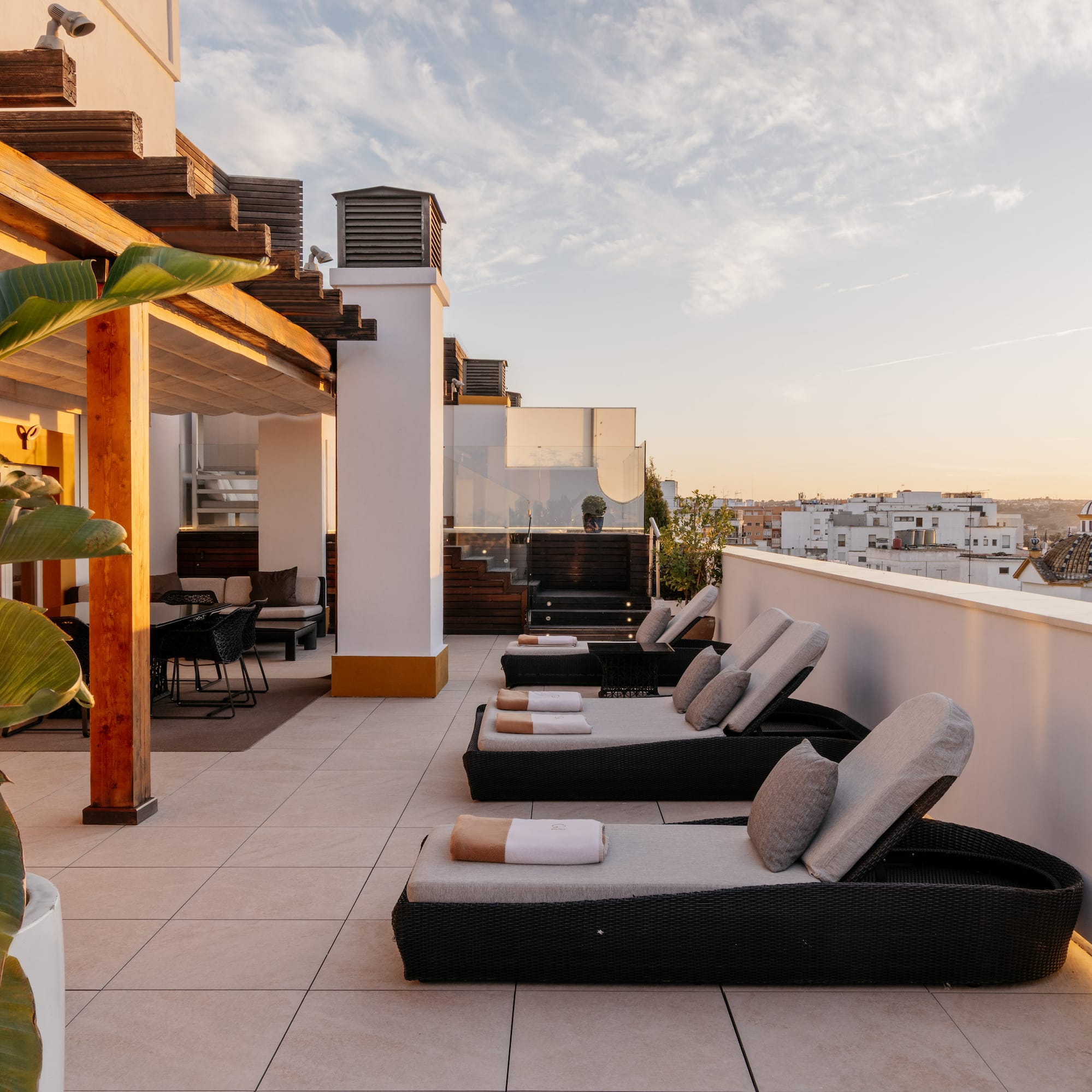 a deck with chairs and a view of a city