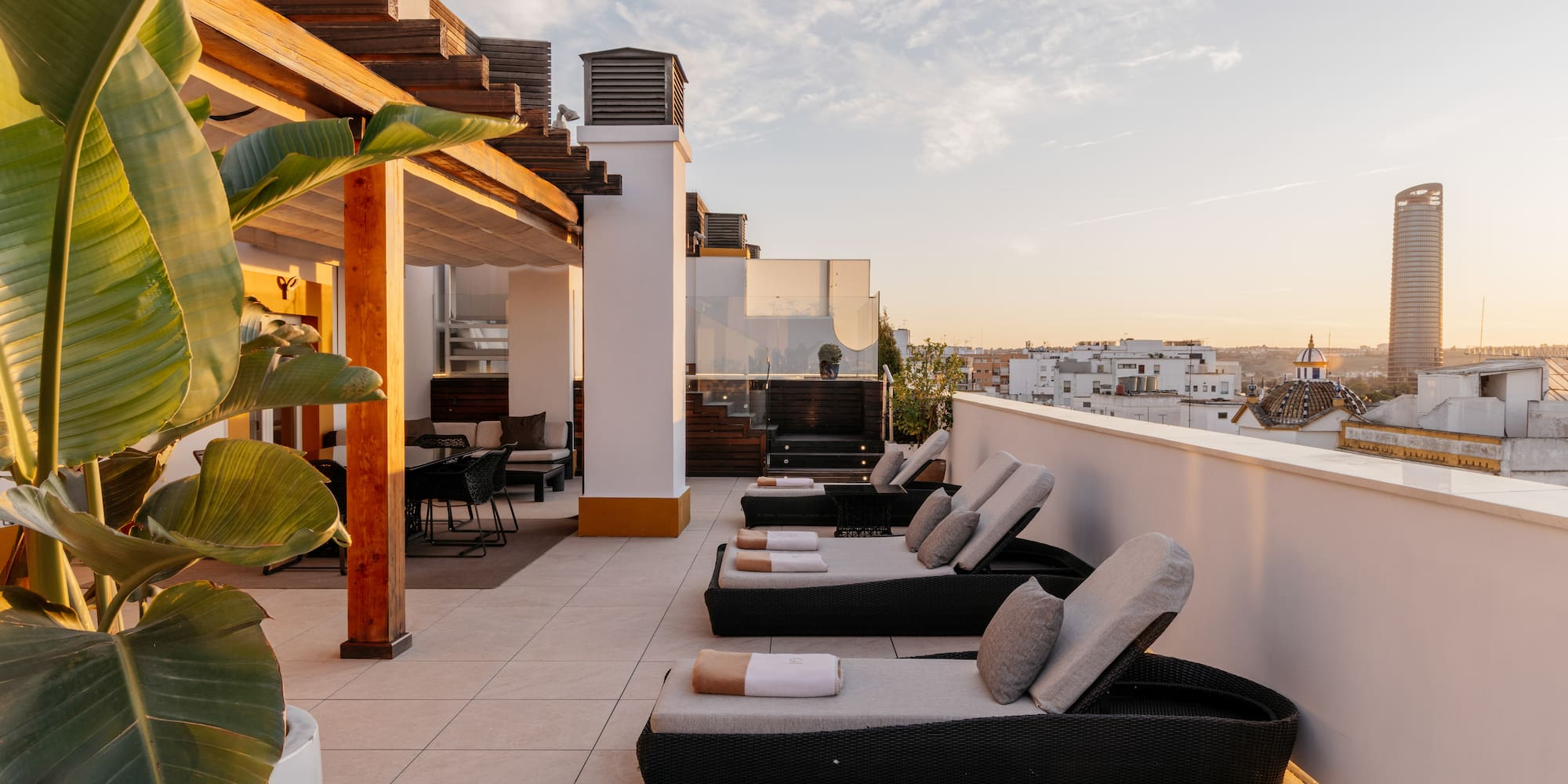 a deck with chairs and a view of a city