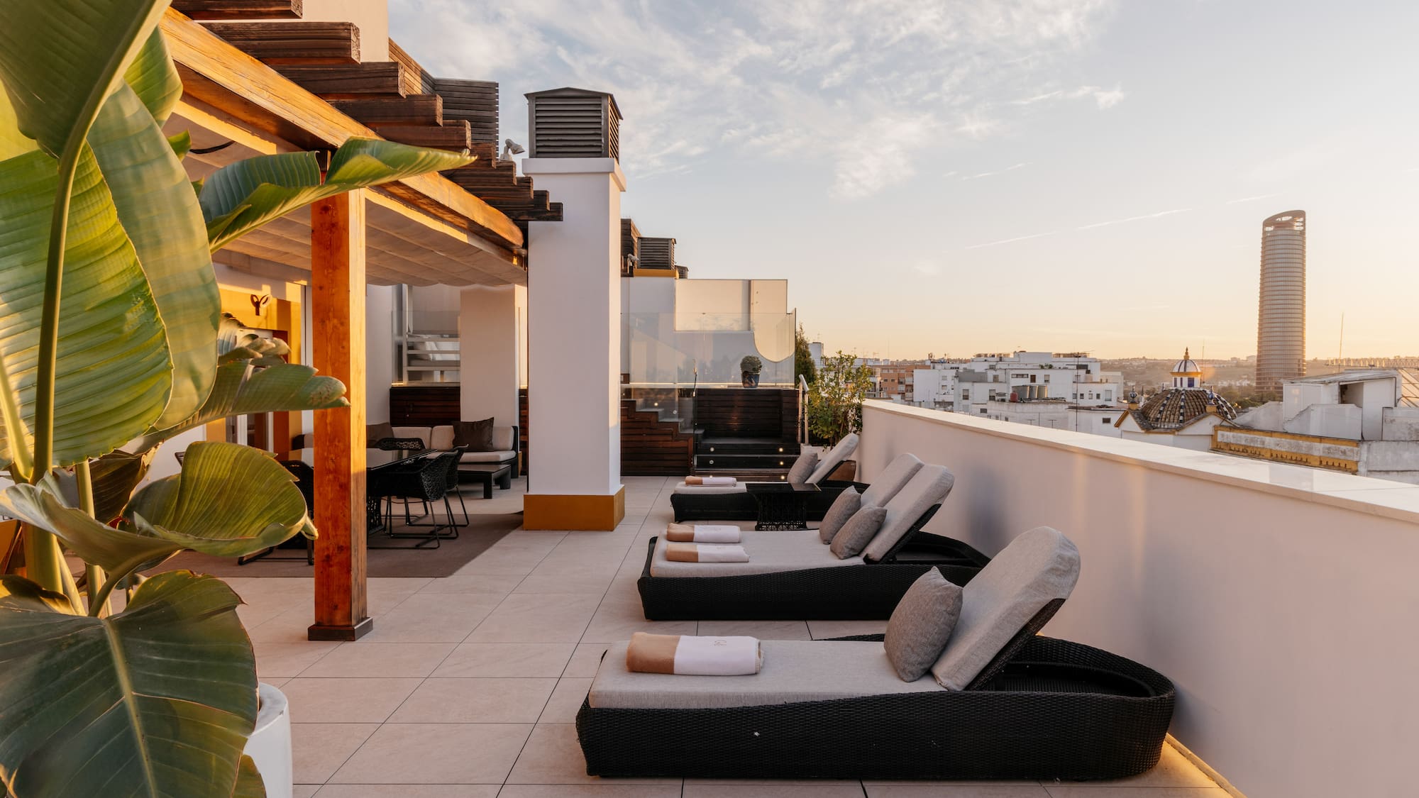 a deck with chairs and a view of a city