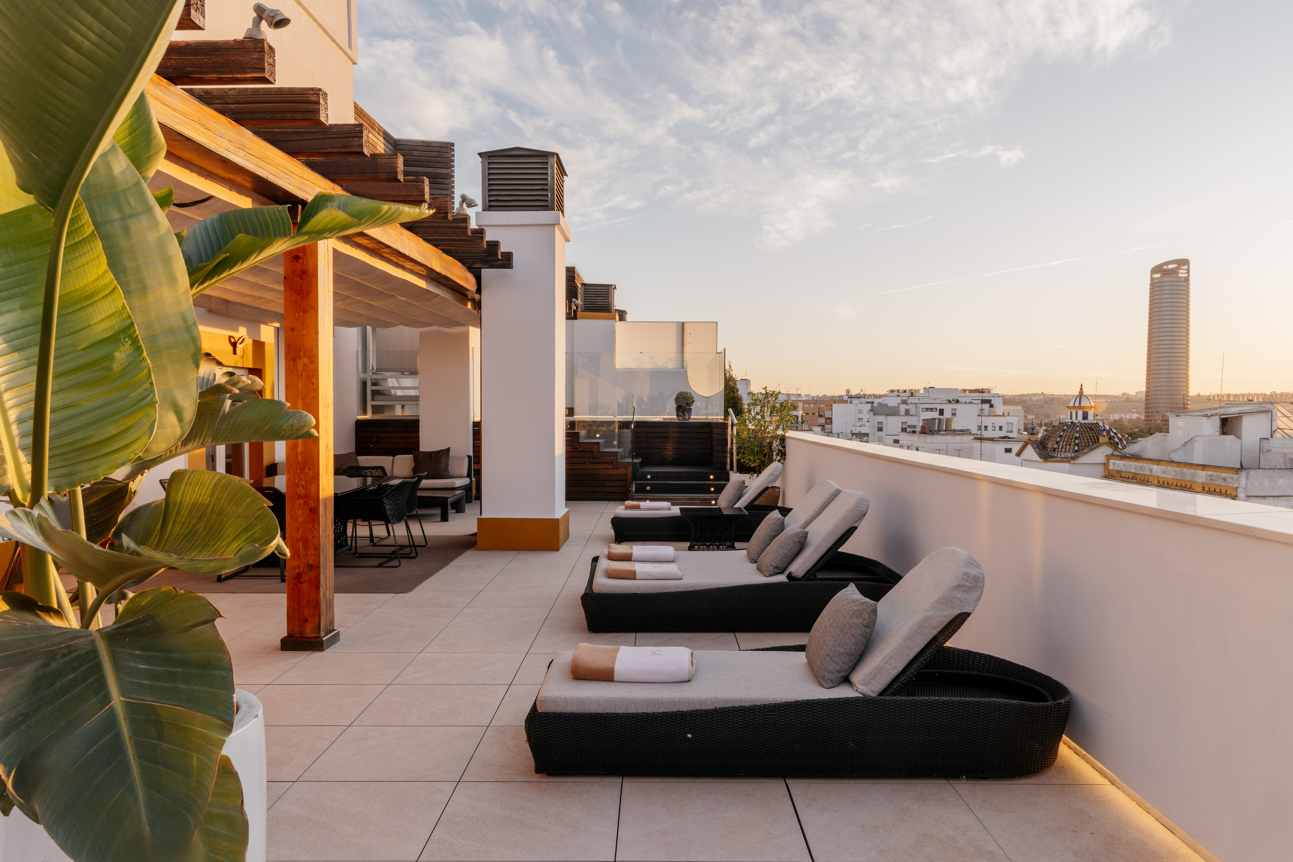 a deck with chairs and a view of a city