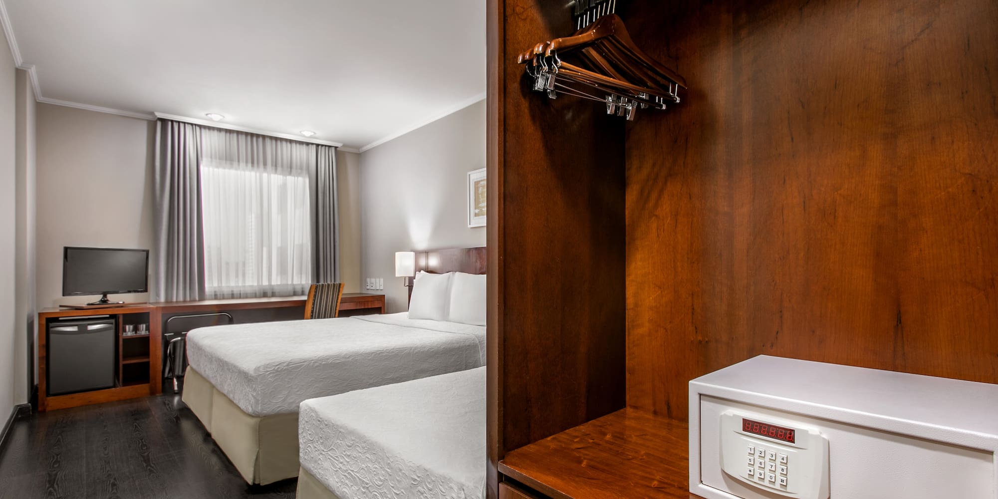 a room with two beds and a small white box