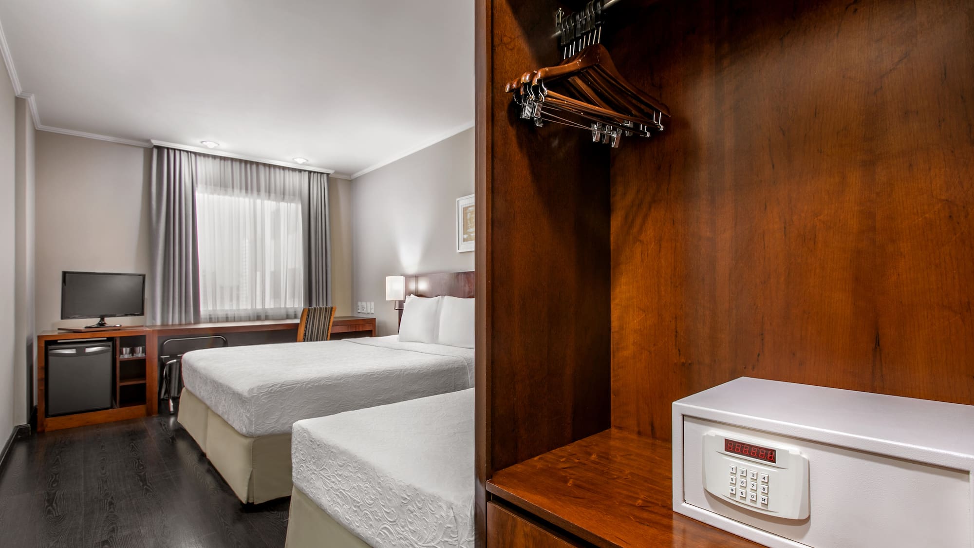 a room with two beds and a small white box